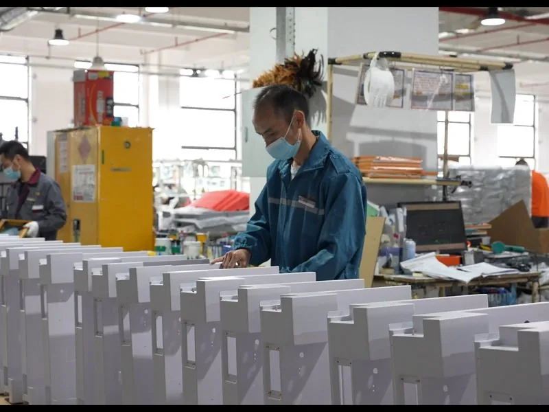 Inspecting cabinet panels before assembly in our plant