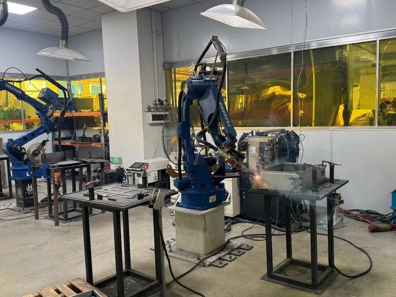 Robotic welding cell welding a steel frame in our plant