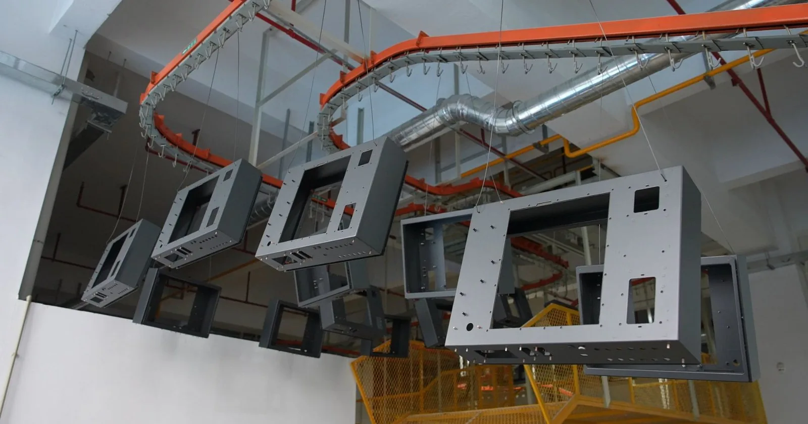 Vending machine cabinet shells moving through the coating line